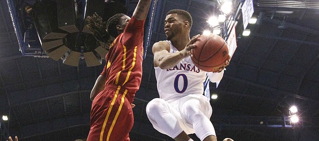 Kansas guard Frank Mason III (0) elevates to throw a pass around Iowa State forward Jameel McKay (1) during the first half, Saturday, March 5, 2016 at Allen Fieldhouse.