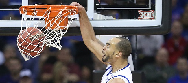 Kansas forward Perry Ellis (34) powers home a dunk before the Kansas State defense during the second half, Thursday, March 10, 2016 at Sprint Center in Kansas City, Mo.