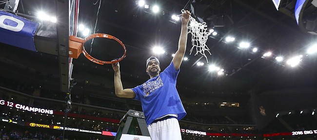 Kansas forward Perry Ellis hoists the net as the Jayhawks celebrate following their 81-71 win over West Virginia, Saturday, March 12, 2016 at Sprint Center in Kansas City, Mo.