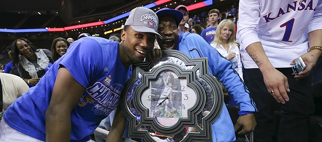 Kansas guard Wayne Selden Jr. (1) celebrates with his uncle Anthony and a big clock featuring a picture of Selden and his dunk from the semifinal game as the Jayhawks celebrate following their 81-71 win over West Virginia, Saturday, March 12, 2016 at Sprint Center in Kansas City, Mo.
