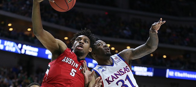 Austin Peay center Chris Horton (5) comes away with a rebound over Kansas forward Jamari Traylor (31) during the first half of a first-round NCAA Tournament game, Thursday, March 17, 2016 at Wells Fargo Arena in Des Moines, Iowa.