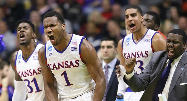 Kansas guard Wayne Selden Jr. (1), Jamari Traylor (31), Landen Lucas and assistant coach Jerrance Howard celebrate a three from teammate Perry Ellis during the first half against UConn on Saturday, March 19, 2016 at Wells Fargo Arena in Des Moines.