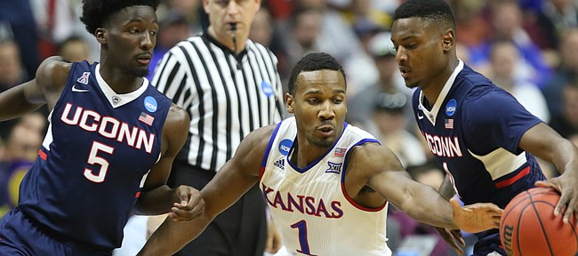 Kansas guard Wayne Selden Jr. (1) eyes the ball as he looks for a steal from Connecticut guard Sterling Gibbs (4) during the first half on Saturday, March 19, 2016 at Wells Fargo Arena in Des Moines. At left is Connecticut guard Daniel Hamilton (5).
