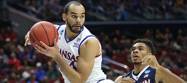 Kansas forward Perry Ellis (34) catches a pass in the paint before Connecticut forward Shonn Miller (32) during the first half on Saturday, March 19, 2016 at Wells Fargo Arena in Des Moines.
