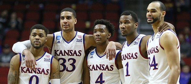 The Kansas starters, Frank Mason III, Landen Lucas, Devonte Graham, Wayne Selden Jr. and Perry Ellis stand arm-in-arm late in the second half as they watch a pair of UConn free throws with the game wrapped up, Saturday, March 19, 2016 at Wells Fargo Arena in Des Moines.