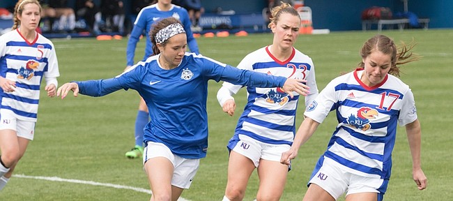 Kansas' Taylor Christie (17) and Hanna Kallmaier (23) attempt to slow down the FC Kansas City offense during their exhibition soccer match on Saturday at Rock Chalk Park.