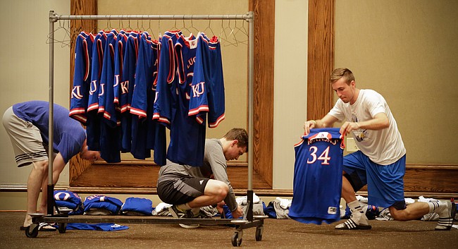 Kansas University men's basketball student managers, Chip Kueffer, Baldwin City, right, Jay Turnipseed, Houston, Texas, left, and Tim Skoch, Hastings, Neb., work to fold and bundle uniforms and other articles of clothing prior to a team meeting on Tuesday, Nov. 24, 2015 at the Westin Maui in Lahaina, Hawaii. The managers abide by a strict procedure for organizing and laundering all of the gear that accompanies the Jayhawks during their travels but often have to improvise on the road when faced with a quick turnaround between games.
