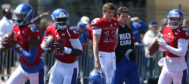 Injured Kansas quarterback Ryan Willis (13) watches from the sidelines as the rest of the quarterbacks warm up prior to kickoff of the Spring Game on Saturday, April 9, 2016 at Memorial Stadium.