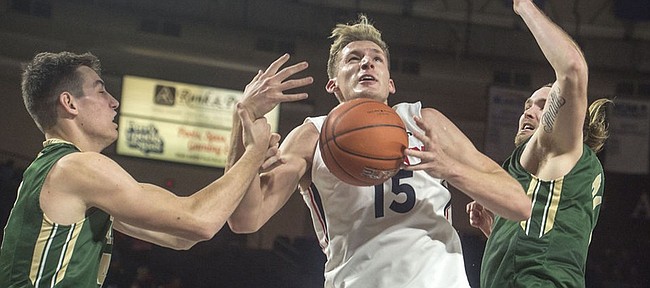Liberty's Evan Maxwell (15) gets fouled going up for a shot in the first half against William & Mary on Tuesday, Nov. 17, 2015, in Lynchburg, Va. Maxwell, a 6-foot-10 sophomore big man, is transferring from Liberty to Kansas University.