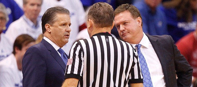 Kentucky head coach John Calipari and Kansas head coach Bill Self have a joint meeting with an official after a double technical foul during the first half, Saturday, Jan. 30, 2016 at Allen Fieldhouse.