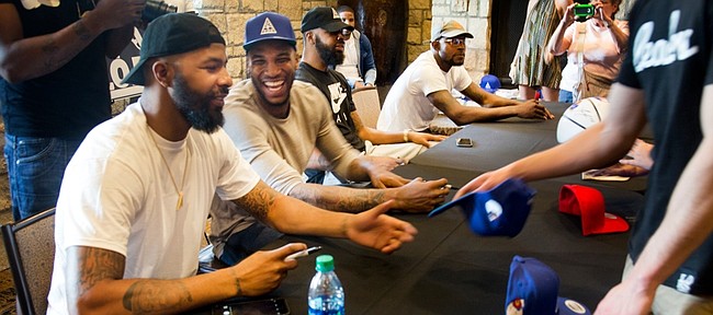 From left, Markieff Morris jokes with Thomas Robinson, as they, Marcus Morris and Mario Little all autographed FOE merchandise at the Oread Hotel Saturday afternoon. To check out the FOE gear, go to: http://www.foeinc.net/images