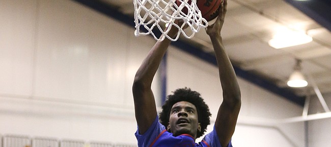 Blue Team guard Josh Jackson soars in for a dunk during the Bill Self basketball camp alumni scrimmage, Wednesday, June 8, 2016 at the Horejsi Athletic Center.