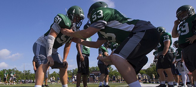 Free State players Jay Dineen (50) and Ben Holiday (53) square up against each other on Tuesday, June 14, 2016 during a Baker University football camp at Lawrence High School.