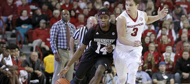 Arkansas' Dusty Hannahs (3) keeps close to Mississippi State's Malik Newman (14) during the second half of an NCAA college basketball game Saturday, Jan. 9, 2016, in Fayetteville, Ark. Arkansas beat Mississippi State 82-68. (AP Photo/Samantha Baker)
