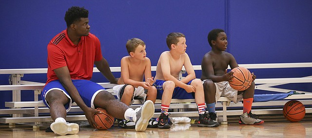 Kansas center Udoke Azubuike sits with skins team players Alec Sievert, left, Brady Johnson and Andrew Nelson during Ben McLemore and Andrew Wiggins' Kansas All-Star Basketball Camp on Wednesday, July 13, 2016 at Sports Pavilion Lawrence.