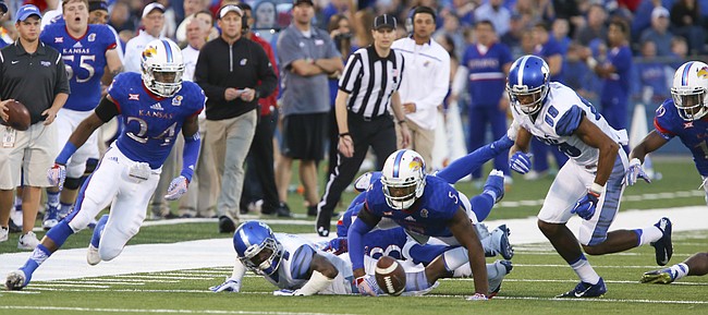 Kansas safety Bazie Bates IV (24) and linebacker Marcquis Roberts eye a fumbled ball during the second quarter on Saturday, Sept. 12, 2015 at Memorial Stadium.
