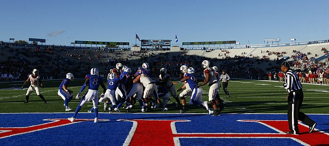 The Kansas defense and Oklahoma offense knock heads near the goal line during the third quarter Saturday, Oct. 31, 2015 at Memorial Stadium.