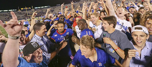 Kansas wide receivers LaQuvionte Gonzalez (1) and Steven Sims Jr. (11) are surrounded by fans during a postgame interview following the Jayhawks' 55-6 win over Rhode Island on Saturday, Sept. 3, 2016 at Memorial Stadium.