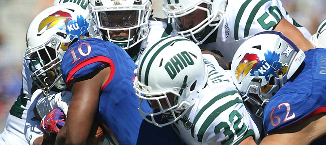 Kansas running back Khalil Herbert (10) is wrapped up by a pack of Ohio defenders during the second quarter on Saturday, Sept. 10, 2016 at Memorial Stadium.