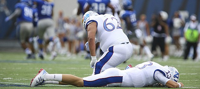 Kansas quarterback Ryan Willis (13) and offensive lineman D'Andre Banks (62) lower their heads in dejection after a Memphis player recovered a Willis fumble running it down the field during the first quarter on Saturday, Sept. 17, 2016 at Liberty Bowl Memorial Stadium in Memphis, Tenn.