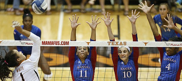 Kansas' Ainise Havil i(11), Tayler Soucie (10) and Jada Burse (4) look to block Texas' Micaya Whit e(1) during a match at Gregory Gym in Austin, Saturday, Sept. 24, 2016.