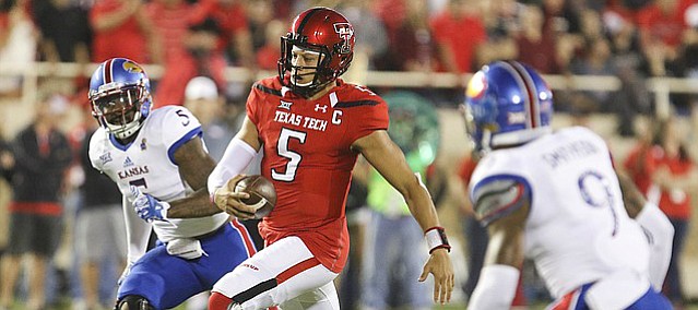 Texas Tech quarterback Patrick Mahomes II (5) runs for a first down past Kansas linebacker Marcquis Roberts (5) during the first quarter on Thursday, Sept. 29, 2016 at Jones AT&T Stadium in Lubbock, Texas.