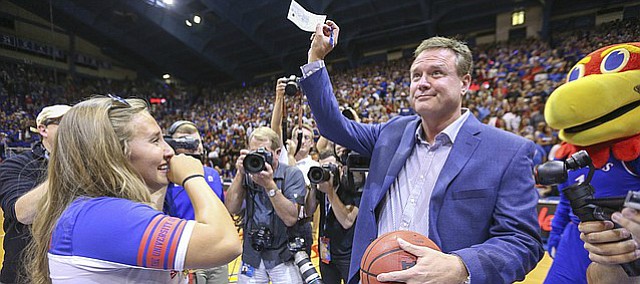 Kansas sophomore Jordan Stiers, Independence, Mo., cries some joyful tears as Bill Self hands over a $10 thousand personal check to her after Brennan Bechard, director of basketball operations, hit a half-court shot for her for the second year in a row during Late Night in the Phog on Saturday, Oct. 1, 2016 at Allen Fieldhouse.
