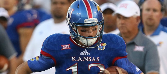 Kansas quarterback Ryan Willis (13) charges up the sideline during the second quarter on Saturday, Sept. 3, 2016 at Memorial Stadium.