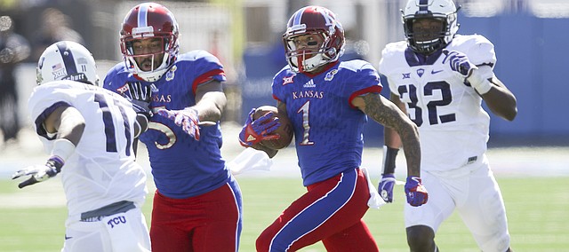 Kansas wide receiver LaQuvionte Gonzalez (1) gets a block from teammate Bobby Hartzog Jr. (5) as he runs for a 70-yard gain during the third quarter on Saturday, Oct. 8, 2016 at Memorial Stadium.