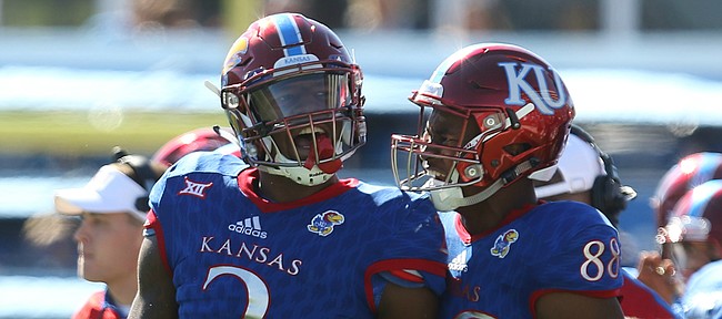 Kansas defensive end Dorance Armstrong Jr. (2) celebrates with Kansas wide receiver Jeremiah Booker (88) after Armstrong forced a fumble during the first quarter on Saturday, Oct. 8, 2016 at Memorial Stadium.
