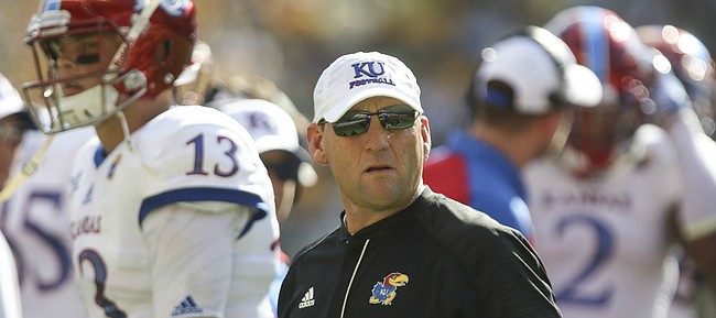 Kansas head coach David Beaty and quarterback Ryan Willis (13) walk back to the sideline after a botched snap by offensive lineman Joe Gibson (77) during the second quarter on Saturday, Oct. 15, 2016 at McLane Stadium in Waco, Texas.