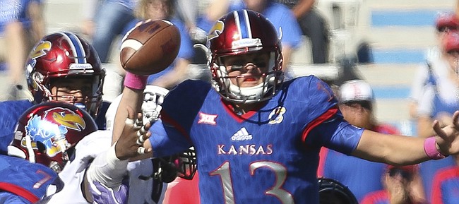 Kansas quarterback Ryan Willis (13) is brought down by TCU defensive tackle Aaron Curry (95) and other Horned Frog defenders on the Jayhawks' final drive of the game on Saturday, Oct. 8, 2016 at Memorial Stadium.
