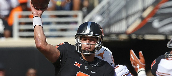 Oklahoma State quarterback Mason Rudolph (2) throws as he is hit by Texas defensive tackle Paul Boyette Jr. (93) in the first quarter of an NCAA college football game in Stillwater, Okla., Saturday, Oct. 1, 2016. (AP Photo/Sue Ogrocki)