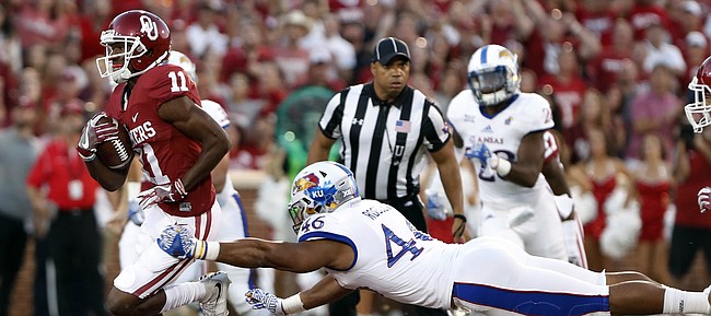 Oklahoma wide receiver Dede Westbrook (11) runs for a touchdown as Kansas defensive end Cameron Rosser (46) misses a tackle during the first half of an NCAA college football game in Norman, Okla., Saturday, Oct.29, 2016.