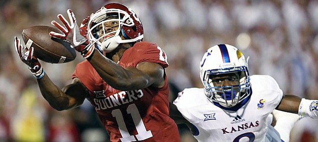 Oklahoma wide receiver Dede Westbrook (11) makes a catch for a touchdown ahead of Kansas cornerback Brandon Stewart (8) during the first half of an NCAA college football game in Norman, Okla., Saturday, Oct.29, 2016.