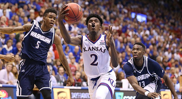 Kansas guard Lagerald Vick (2) makes a move to the bucket between Washburn guard Javion Blake (5) and guard Tyas Martin (13) during the second half, Tuesday, Nov. 1, 2016 at Allen Fieldhouse.