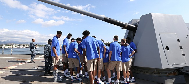 The Kansas Jayhawks congregate underneath a 5 inch cannon at the front of the USS Chafee, a guided missile destroyer, during a tour of some of the Pearl Harbor sites on Wednesday, Nov. 9, 2016 in Honolulu, Hawaii.