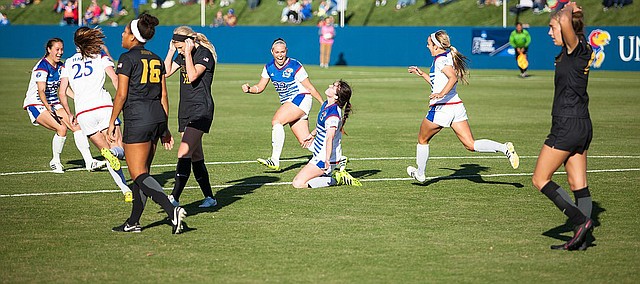 Kansas junior forward Lois Heuchan slides to the turf after scoring the game-winning goal against Missouri in the first round of the NCAA Tournament on Sunday, Nov. 13, 2016 at Rock Chalk Park. Senior Hanna Kallmaier (23) pumps her fist in the background. 