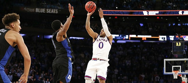 Kansas guard Frank Mason III (0) puts up the final shot over Duke guard Matt Jones (13) with seconds remaining for the win on Tuesday, Nov. 15, 2016 at Madison Square Garden in New York.