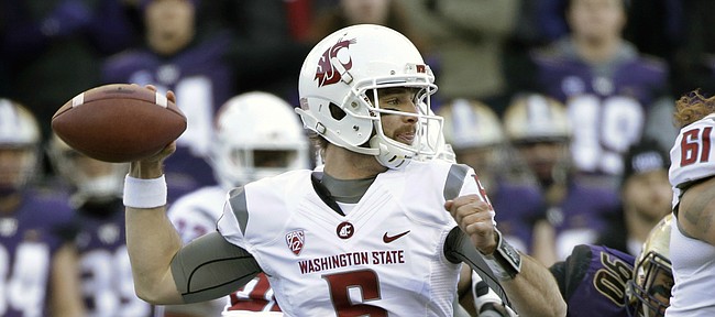 Washington State quarterback Peyton Bender (6) drops back to pass against Washington in the first half of an NCAA college football game Friday, Nov. 27, 2015, in Seattle. (AP Photo/Elaine Thompson)
