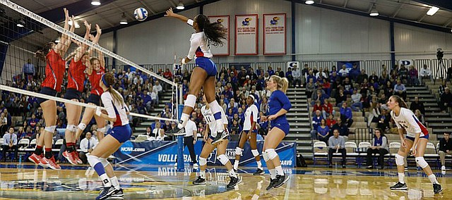 Kansas outside hitter Jada Burse (4) makes a kill for a point in the Jayhawks three-set sweep against Samford University in the first round of the NCAA women’s volleyball tournament Thursday, Dec. 1, at Horejsi Family Athletics Center.