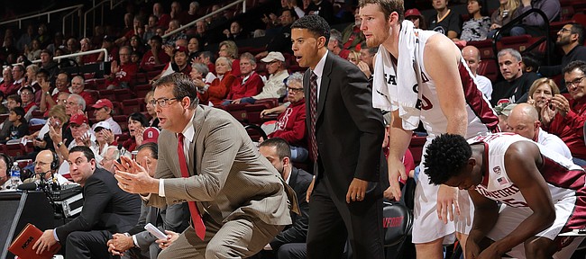 First-year Stanford coach Jerod Haase, who played at Kansas from 1995-97, will return to Allen Fieldhouse on Saturday, Dec. 3, 2016, to lead his Cardinal against Bill Self and the Jayhawks. This photo, taking during a Stanford game earlier this season, shows Haase (in red tie) in a pose similar to the defensive stances that made him a fan favorite during his days at Kansas.