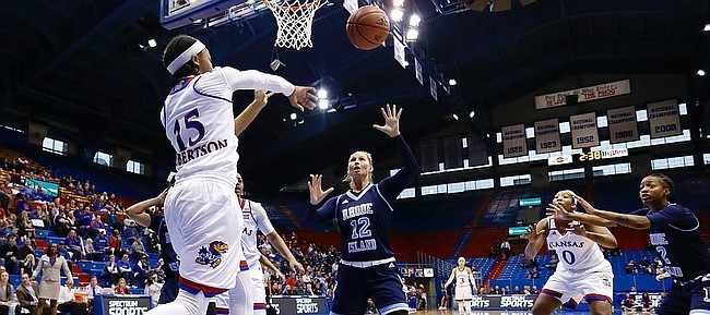 Kansas guard Aisia Robertson (15) makes a pass from beneath the basket in the Jayhawks win against the Rhode Island Rams Sunday, Dec. 11 in Allen Fieldhouse. 