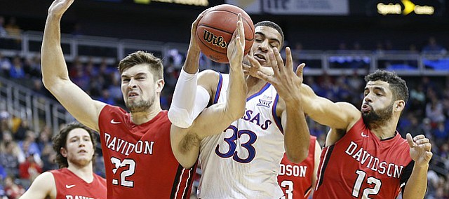 Kansas forward Landen Lucas (33) gets tangled up between Davidson forward Will Magarity (22) and Davidson guard Jack Gibbs (12) going for a loose ball during the first half, Saturday, Dec. 17, 2016 at Sprint Center.