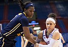 Kansas’ Jessica Washington (3) wrestles the ball from West Virginia’s Teana Muldrow (11) late in the third quarter of Wednesday night’s game. West Virginia won, 62-51. 