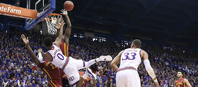Kansas guard Frank Mason III (0) is fouled on the shot by Iowa State forward Solomon Young (33) during the first half, Saturday, Feb. 4, 2017 at Allen Fieldhouse.