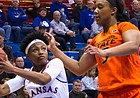 Kansas’ Aisia Robertson (15) goes up for the layup over Oklahoma State’s Diana Omozee (5) Wednesday at Allen Fieldhouse.