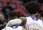 Kansas guard Josh Jackson (11) puts his arm around teammate Frank Mason III (0) during a timeout in the first half, Saturday, Feb. 11, 2017 at United Supermarkets Arena in Lubbock, Texas.