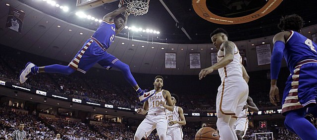 Kansas guard Lagerald Vick (2) scores over Texas guard Eric Davis Jr. (10) during the first half of an NCAA college basketball game, Saturday, Feb. 25, 2017, in Austin, Texas.