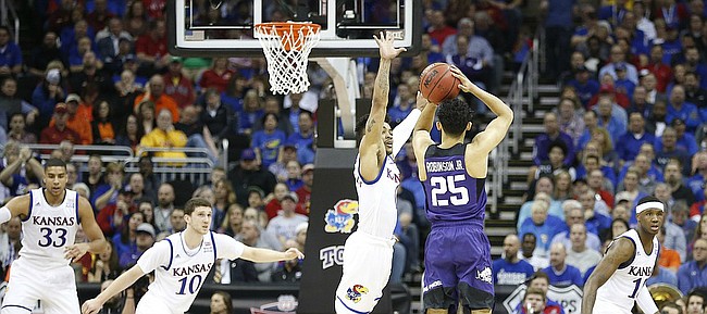 Kansas guard Frank Mason III (0) lunges to defend against a three from TCU guard Alex Robinson (25) during the first half, Thursday, March 9, 2017 at Sprint Center.